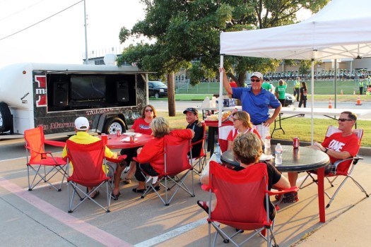 Jaime Riggle, her husband Darryl and friends tailgate on Sept. 6 before the home football against Arlington High. 