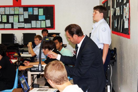 Assistant golf coach Matthew Schwolert and Algebra 1 teacher assists students in class. 