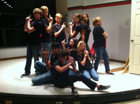 Students (back row, left to right)  senior Jake Herrel, junior Tyler Stern, sophomore Davis Gilmartin, senior Paige Brinzo, sophomore Siete White, sophomore Kendra Felmly, (front row, left to right) junior Aditya Singh, senior Beau McGary, junior Cat Cakmis and sophmore Hope Warner perform a skit in the school cafeteria. 