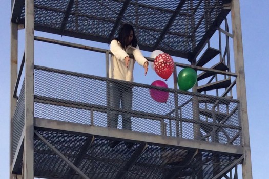 Science Honor Society president, senior Amanda Wang, drops her egg off of the band tower. 