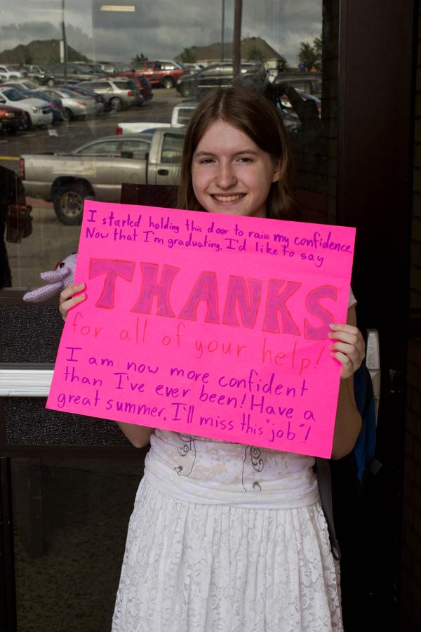 Senior Ryleigh Tyson holds a sign thanking everyone for helping her self confidence. 