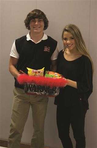 Seniors Dana Schultz and Hunter Warner exchange the Gameday Girlies bucket. This is Warners second year on varsity and he appreciates all of the support.