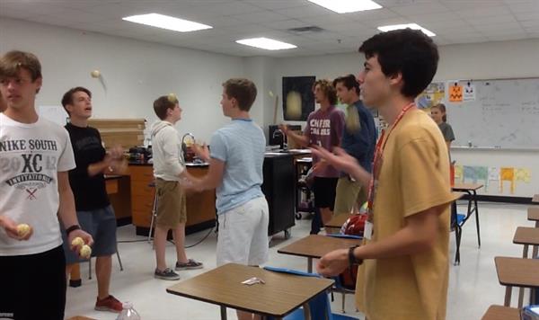 From left to right facing camera: Andrew Duffy 11, Logan Gutwein 12, and Alec Blair 11, practice their three-ball juggling skills in Scott Hinsley’s classroom. They also juggle scarves and bowling pins.