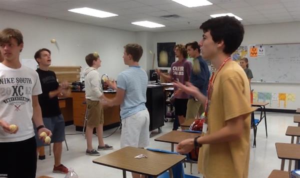 From left to right facing camera: Andrew Duffy 11, Logan Gutwein 12, and Alec Blair 11, practice their three-ball juggling skills in Scott Hinsley’s classroom. They also juggle scarves and bowling pins. 