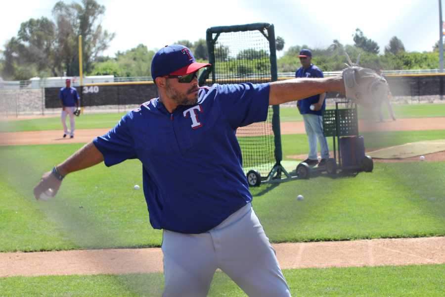 Iván Rodríguez throws the ball with the some of the current Rangers players. He was a catcher for the team from 1991 to 2002.