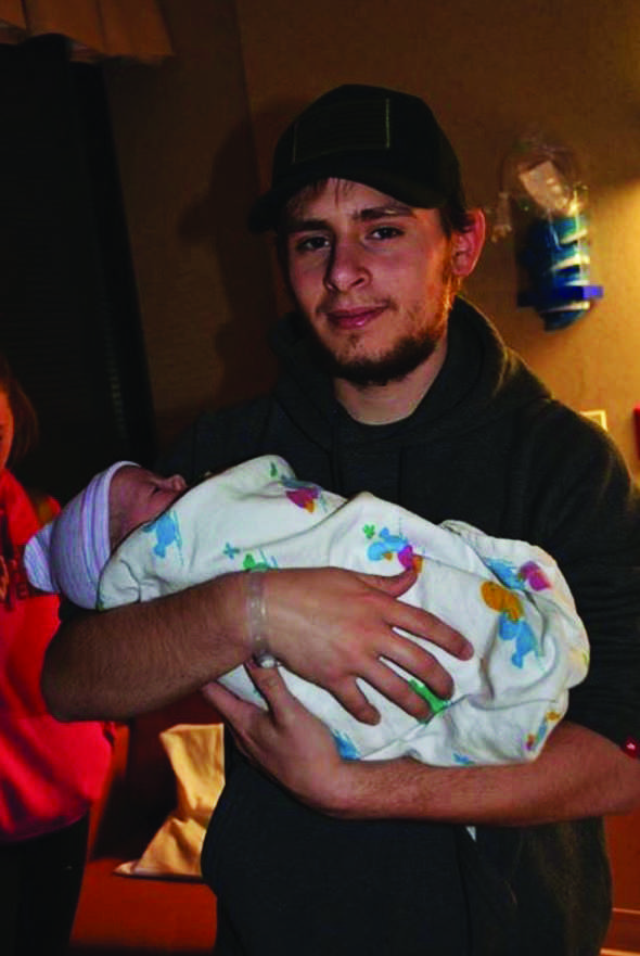 Senior Matthew McClay holds his son in the hospital. He was born on February 12th at the Medical Center of Lewisville. 