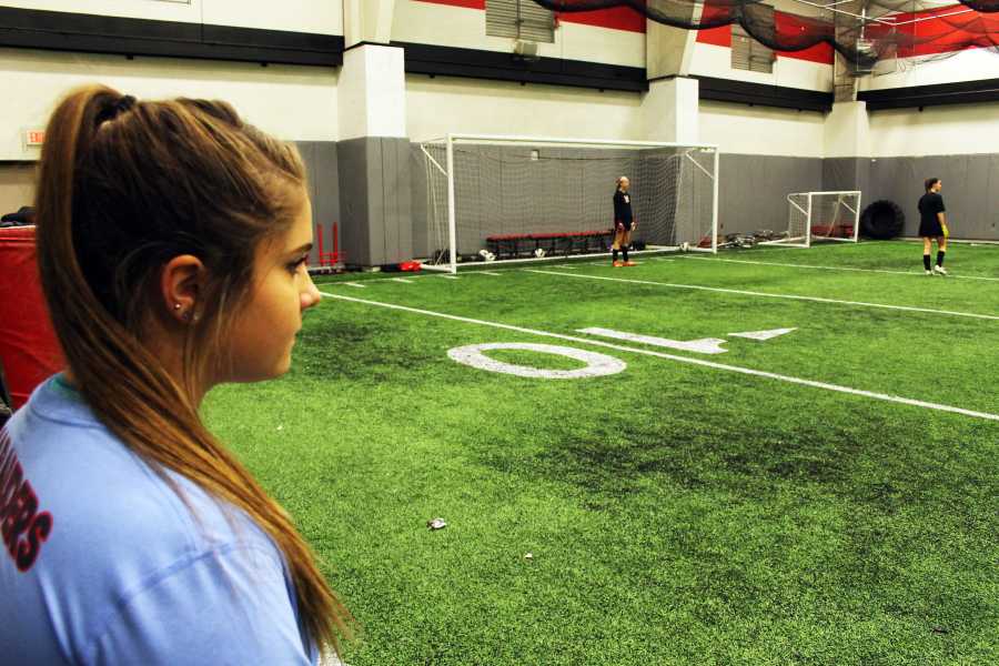 Salls looks on from the sidelines while her teammates train. She will play soccer next year at the University of Central Oklahoma, located outside of Oklahoma City. 