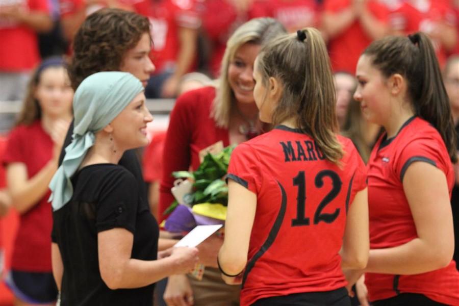 Amanda Thomas was the Heart of a Marauder recipient for 2015. She received the donations and a bouquet of flowers alongside her son Gage, Coach Cron, and the varsity players. 