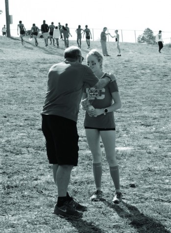 Below: Coach Telaneus gives a pep talk to Ashton Hutcherson following the conclusion of a meet. Hutcherson is a senior on the girls cross country team.