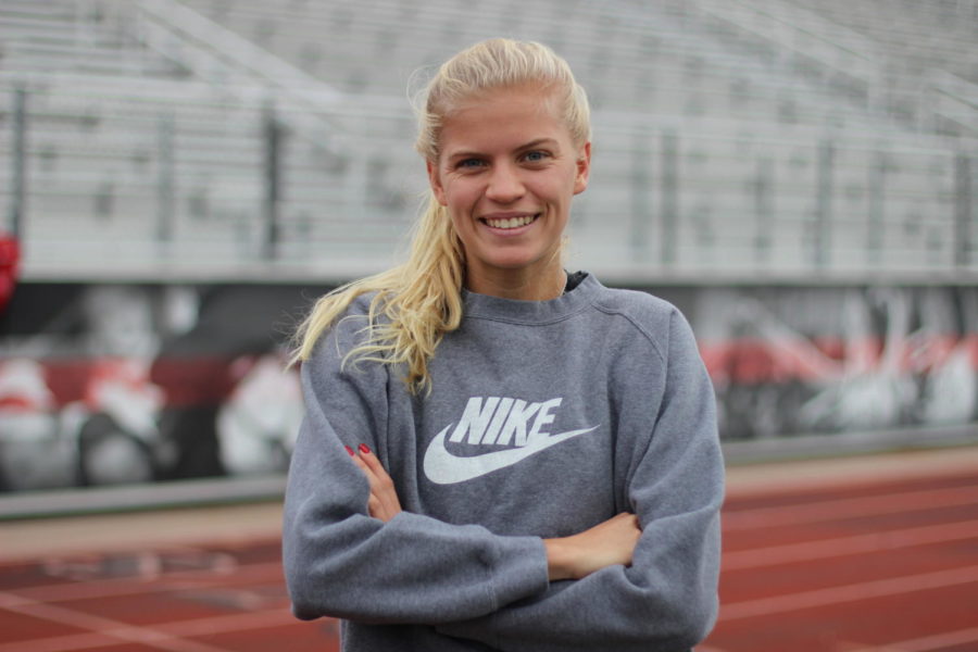 Quinn Owen stands on the stadium track before her cross country practice that occurs every weekday before school.