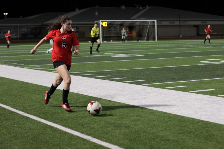 During the varsity game, sophomore Caroline Hilliard runs toward the goal. The team ended their season after their game against Byron Nelson on March 29. 