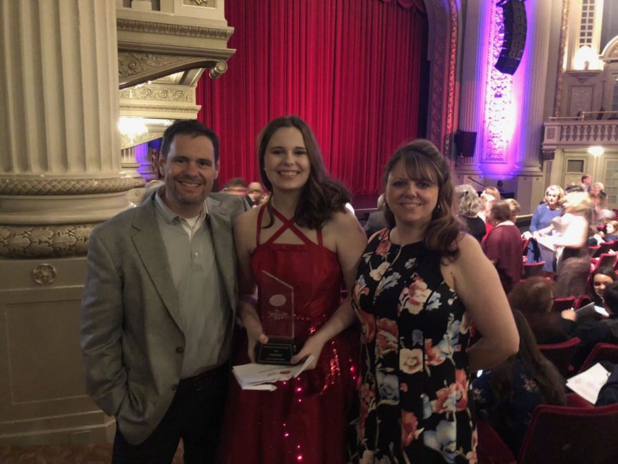 Senior Bri Johnson stands with her parents, Brett and Christie Johnson, holding the Schmidt and Jones Award that she won for her costumes in “Hairspray.” She won the same award last year for her costumes in the “Beauty and the Beast.”
