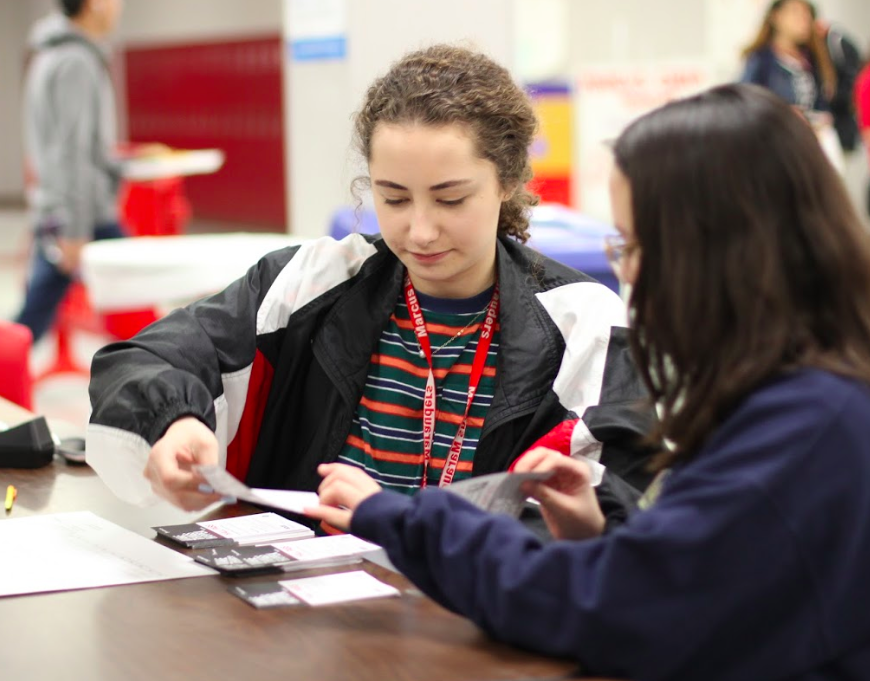 Seniors Kate Bauder and Chloe Agis help students sign up for the annual blood drive sponsored by Carter Bloodcare on March 19. MEDS Club members assist with the drive to gain experience. 