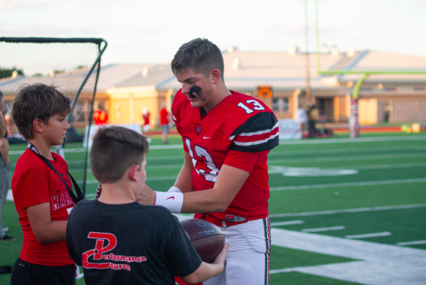 Junior quarterback Garrett Nussmeier tests the air pressure of footballs before last weeks game against Irving High School. 