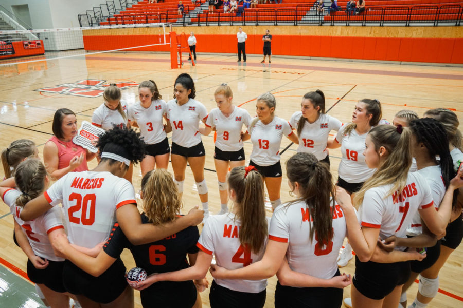 Before the start of the game coach Barker encourages the players to do their best during a team huddle. This is Barker’s fourth year coaching at the school. 