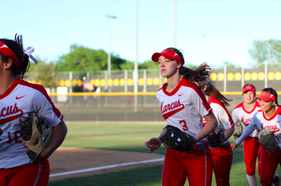 Sophomore Haidyn Sokoloski runs onto the field with her teammates at a varsity game last season. 