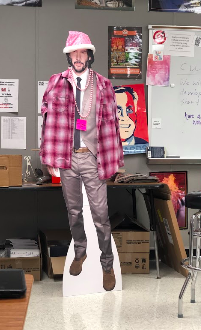 The newest member of The Marquee Staff, a Keanu Reeves cut out, celebrates pink out along other students during spirit week.