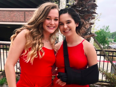 Senior Emma Vega (right) smiles with her teammate, senior Corey McGrath (left), at her swim banquet junior year. Emma had surgery on her left arm the week before the dinner and had to wear an arm sling to the event.