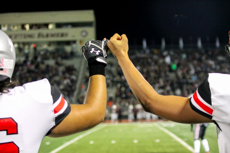 Players, coaches and spectators took part in the Marauder tradition of linking pinkies during the game. 