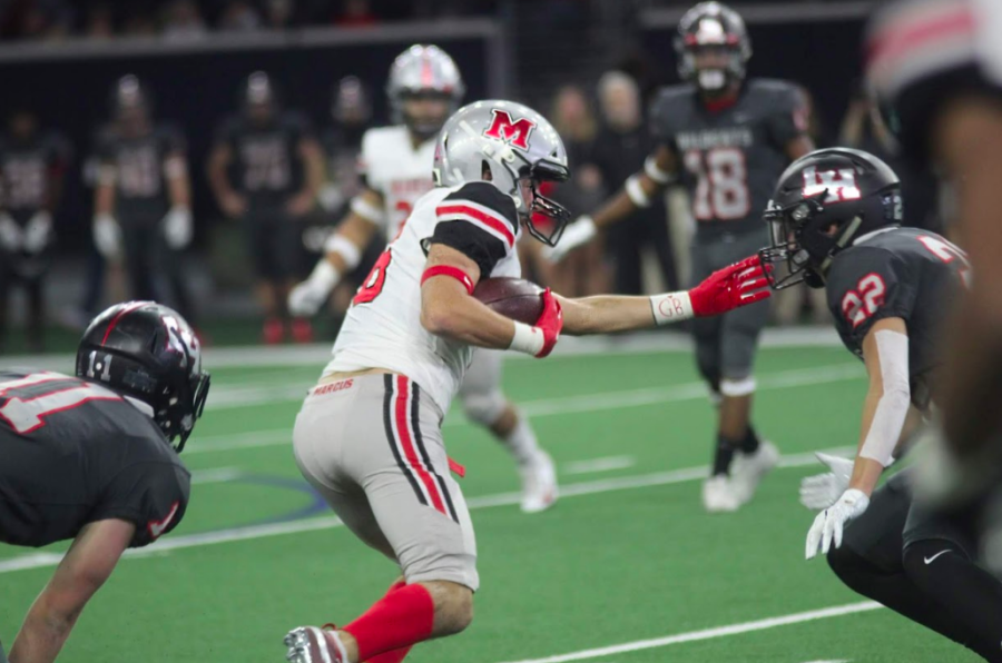 Junior wide receiver Tyler Schott runs with the ball before being tackled towards the end of the first half.