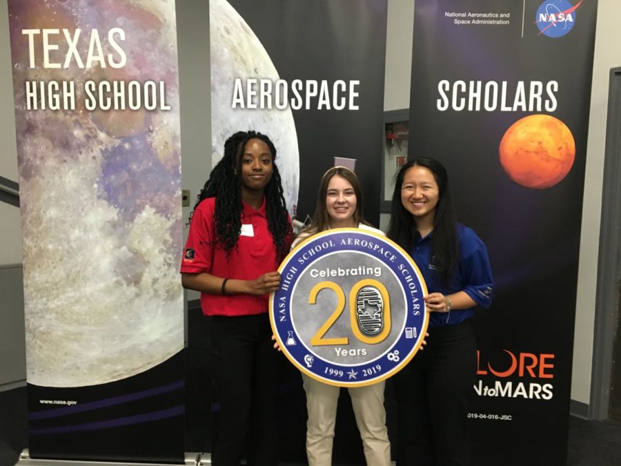 Senior Carol Anne Starks (middle) holds a sign with two other students attending the High School Aerospace Scholars program at the NASA facility in Houston, TX. Carol Anne’s 10-person group was tasked with studying the geography of Mars. 