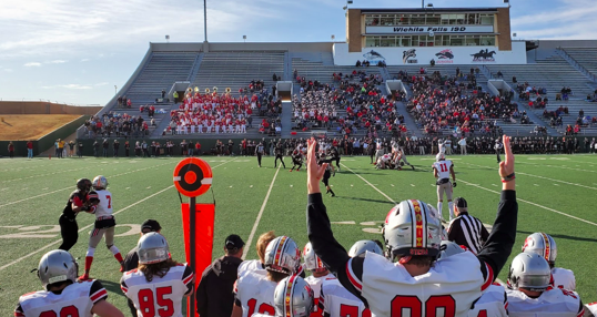 The Marauders watch from the sidelines as their teammates play the Tascosa Rebels on the field. The game ended in a 46-14 loss for the Marauders.