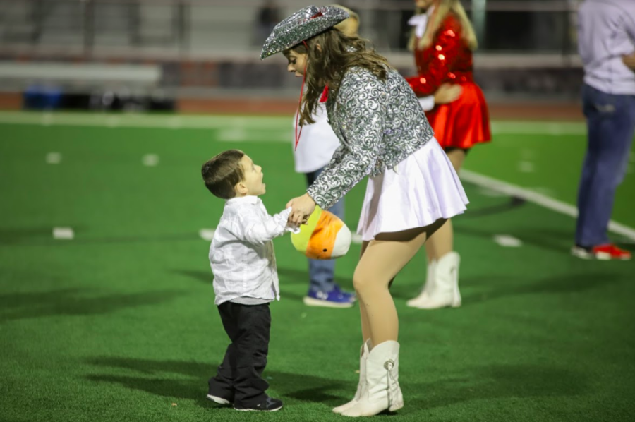 Junior Marquette officer Emily Reynolds performs during halftime at the football game against the Irving MacArthur Cardinals on Nov. 2. The Marauders won 49-13. 