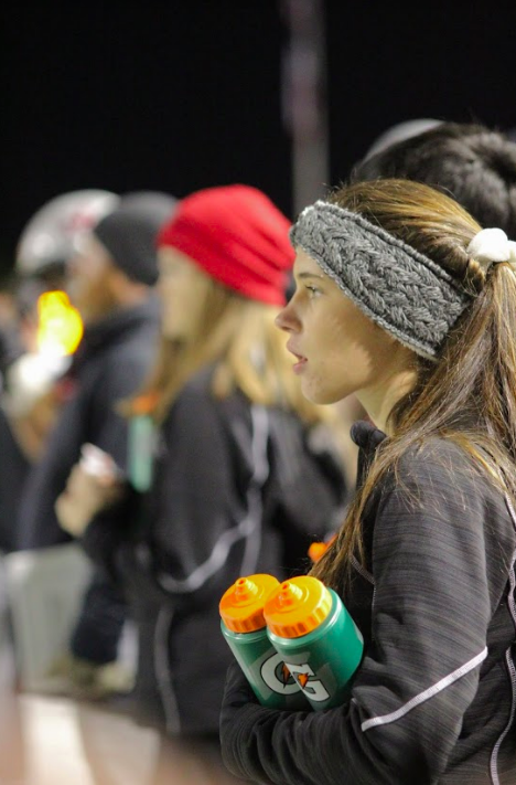 Junior and athletic trainer Sydney Jones watches the football players at the Battle of the Axe on Nov. 8. Student trainers go to sporting events and provide aid to athletes. 