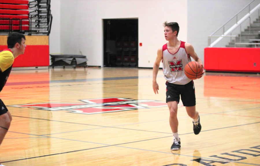 Senior Garrett Walters dribbles the ball down the court during a practice. 
