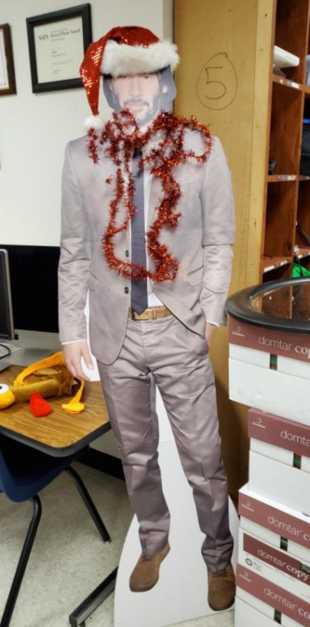 The newsrooms Keanu Reeves cut out got in the Christmas spirit with red tinsel and a Santa hat. 