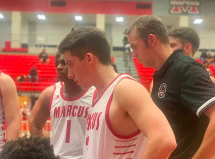 Senior Ryan Lee huddles with the rest of the team as they discuss the game ahead. The Marauders beat the Irving Tigers 65-32. 