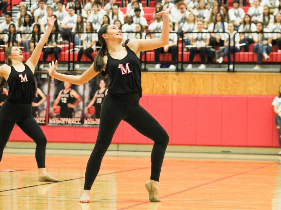 Junior Tristan Finn performs a dance routine with the rest of the Marquettes during the pep rally, which was held to recognize the spring sports.
