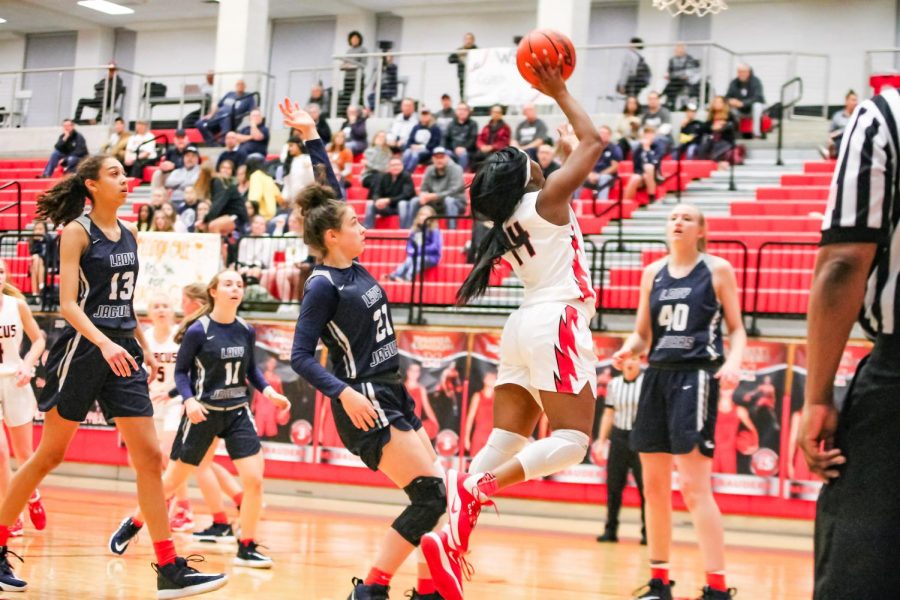 Junior MJ Jefferson shoots the ball at the game on Feb. 4. The annual game was held to honor Coach Gabels battle with cancer.