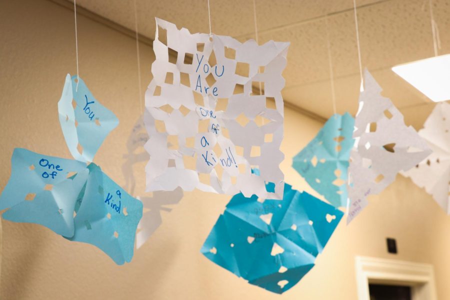Paper snowflakes decorated with encouraging messages hang on the ceiling of Kyle’s Place during Christmas.