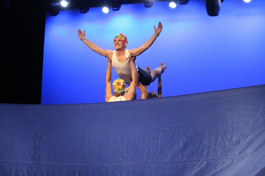 Senior Garrett Karbs is lifted into the air during his synchronized swimming routine for the talent portion of the competition. The annual Mr. Marcus pageant was held last night and Karbs came out on top.