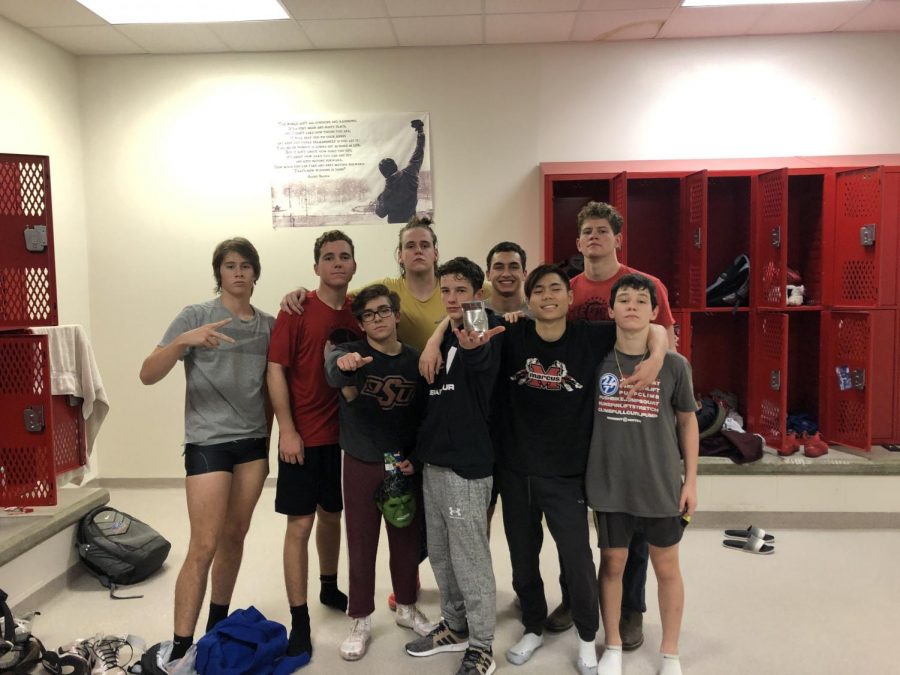 Members of the wrestling team show off their can of beans after a morning workout. The team practices Tuesday through Thursday from 6 - 7:30 a.m. to get ready for their meets. 