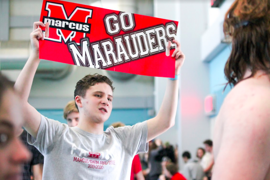 Junior Matthew Hill supports swim at their meet on Jan. 18. He and others encouraged teammates during their events.