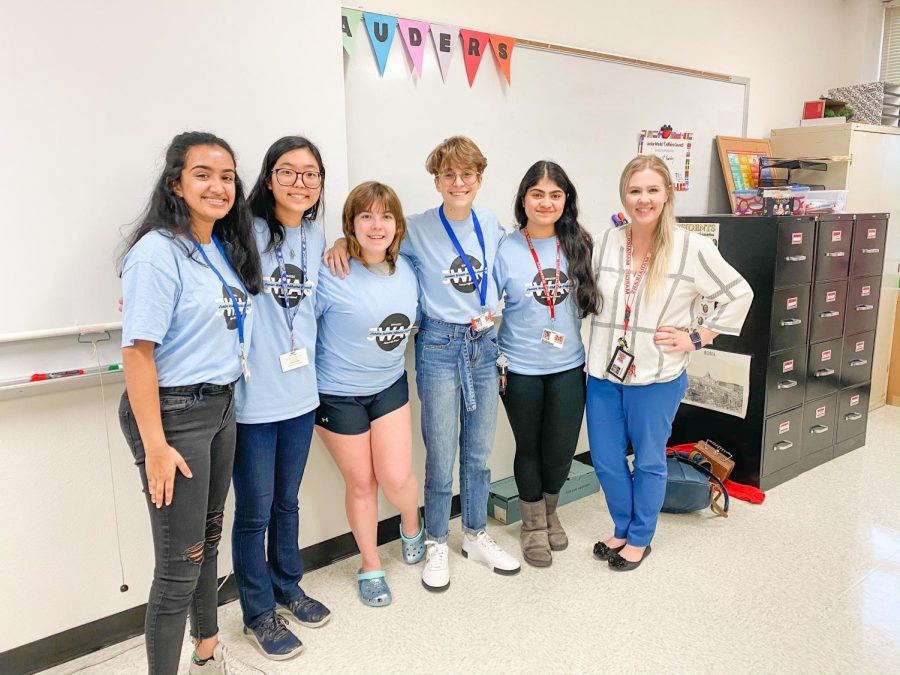 Officers Angela Abraham, Fiona Chung, Destiny Simpson, Renee Gomez, Neha Yawalkar, and sponsor Kaitlyn Wilson stand together. They discussed education in third world countries during the February meeting.