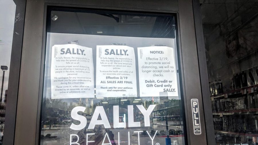 The Flower Mound Sally Beauty Supply posts flyers announcing changes being made due to the COVID-19 pandemic on March 21.