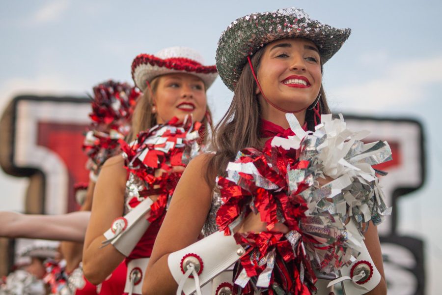 Senior Marquette officer Bella Fortino leads her line onto the field to greet the players at the start of the Sept. 13 football game. The Marquettes recently decided to postpone their annual spring show and auditions in response to COVID-19.