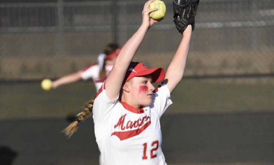 Junior Matie Wolkow pitches at a home softball game. She has had the jersey number 12 since she started playing at the age of 6.