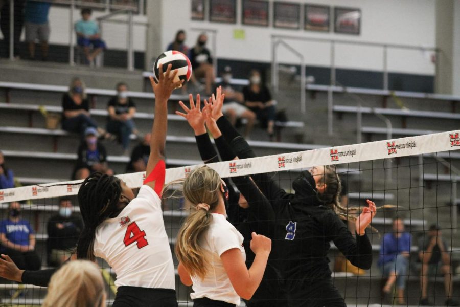 Junior Ifenna Cos-Okpalla jumps to block the ball.