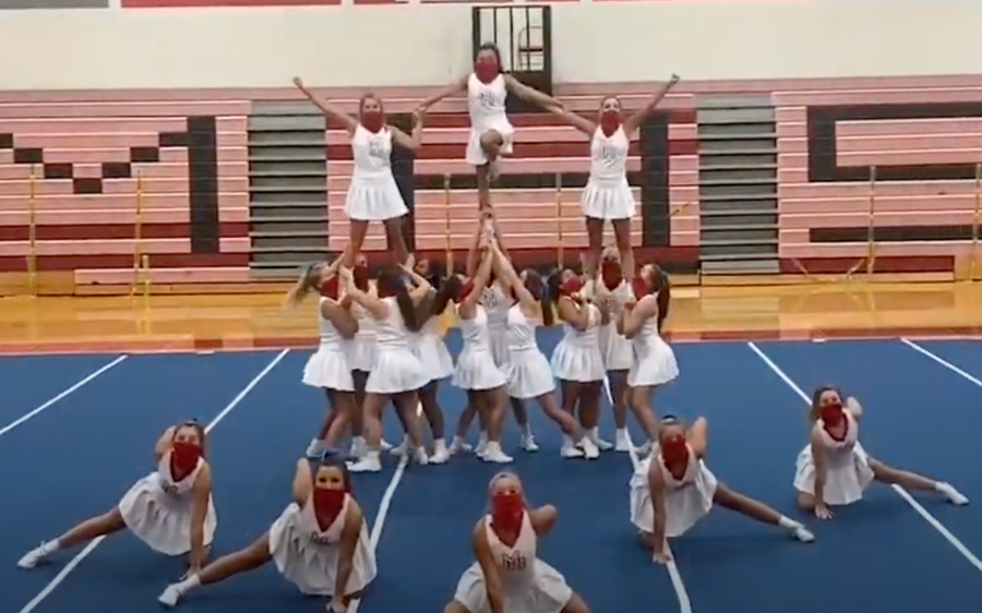 A screenshot from the virtual pep rally shows the cheerleaders performing a routine while wearing face coverings.