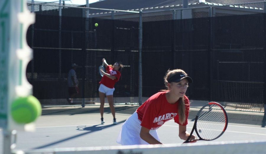 Senior+Mary+Ann+Lu+serves+the+ball+as+junior+Ella+Loxley+stands+in+ready+position+near+the+net+during+their+match+against+The+Colony+Cougars+on+Oct.+9.