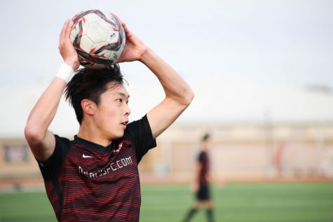 Junior Andrew Wang prepares to throw the ball onto the field during the Marauders game against Rowlett High School on Jan. 16.