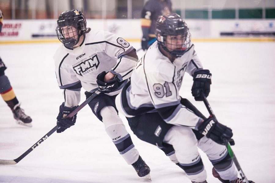 Junior Griffin Joy (86) enters the offensive zone with FMM teammate, Miles Mcgarvey during their second game against Denton County which resulted in a 2-1 win for FMM. 