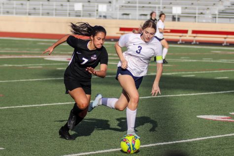 Sophomore Bella Campos chases after the ball before stealing it back for her team.