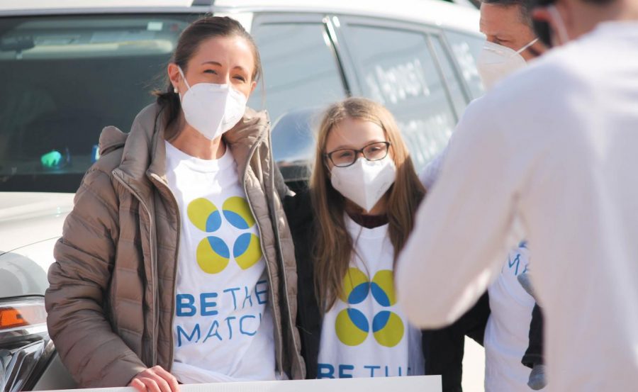 Briarhill Middle School student Audrey Gronberg and her mother, Kim, welcomed donors during the bone marrow drive on Jan. 9. Over 300 people drove through to register
as donors. 