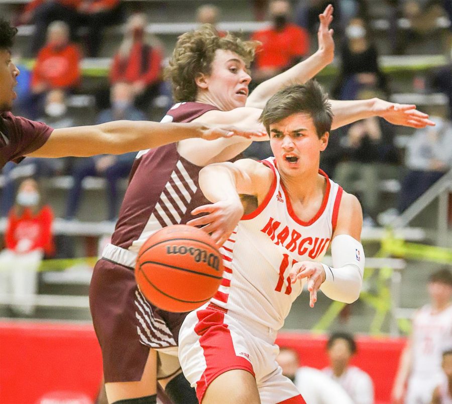 Senior Nick Donnelly dodges Plano opponent as he passes the ball to his teammate. The team won the game 65-43.