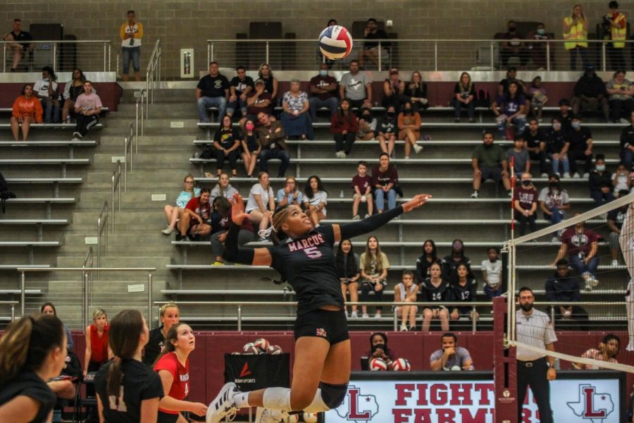 Senior Ifenna Cos-Okpalla jumps before slamming the ball.
